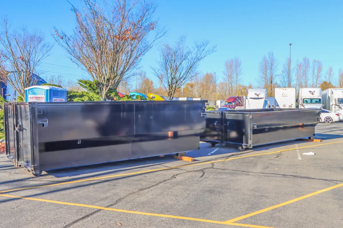 Professional dumpster rental service with roll-off container on residential driveway in Edinboro
